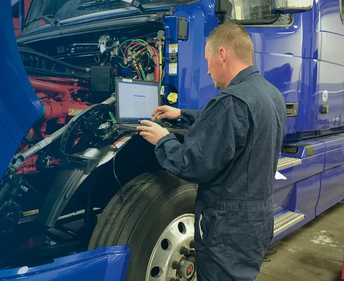 Continental Truck Service technician working on truck engine