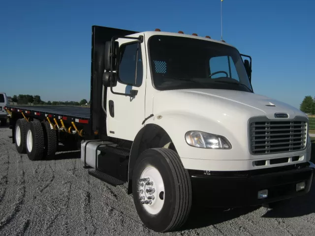 See a Freightliner flatbed truck with a forklift kit on back now.